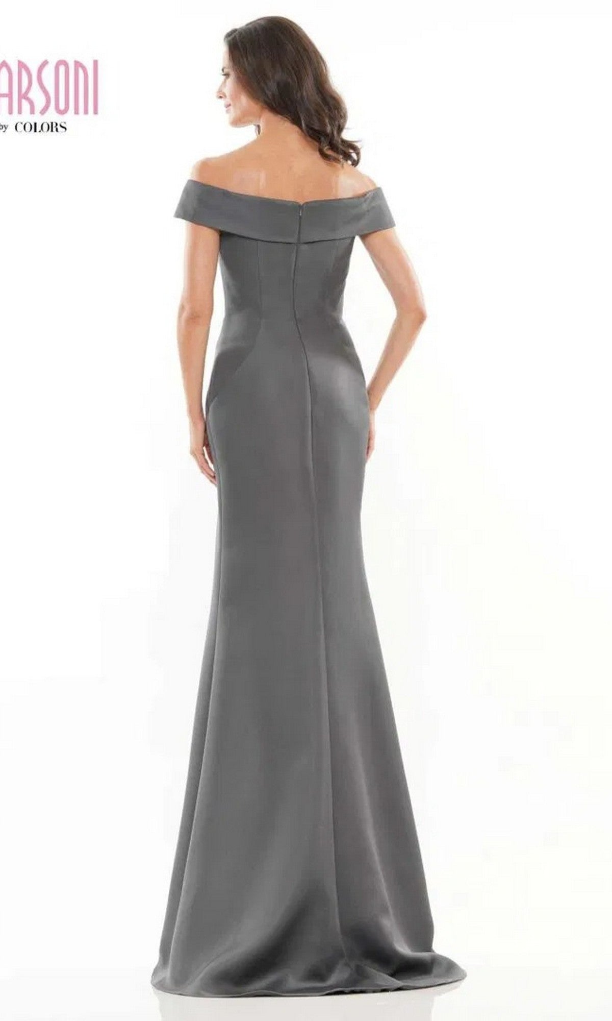 A woman in the Marsoni MV1153 long formal dress stands facing away, showing off the off-the-shoulder style, fitted silhouette, and back zipper.